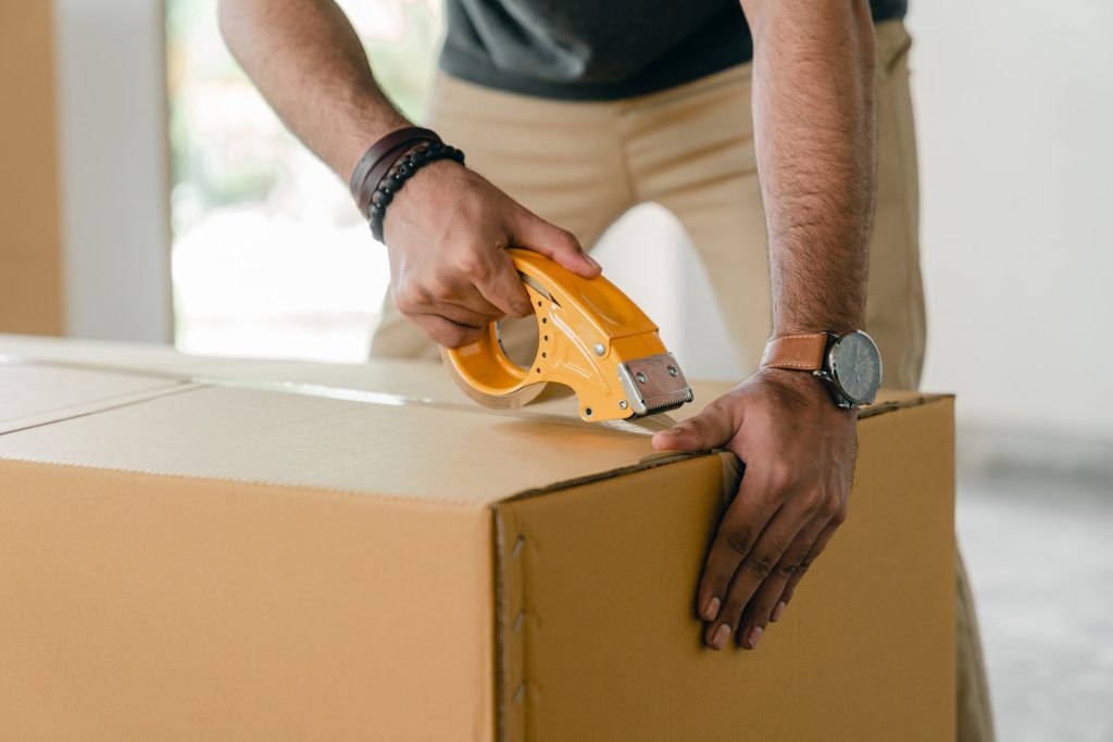 Man cutting open cardboard box