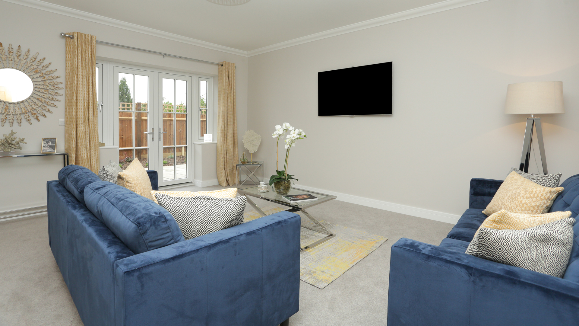 Cobnut Park plot 6 living room blue sofas and a grey carpet.