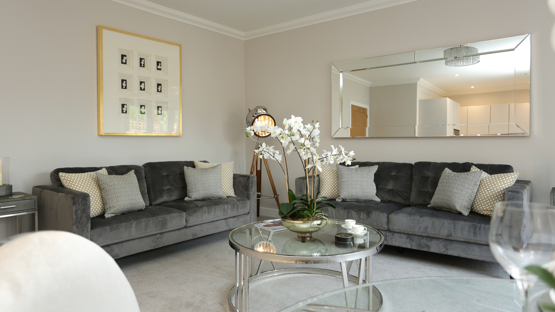 Cobnut Park living room with a mirror, photo and grey sofas.