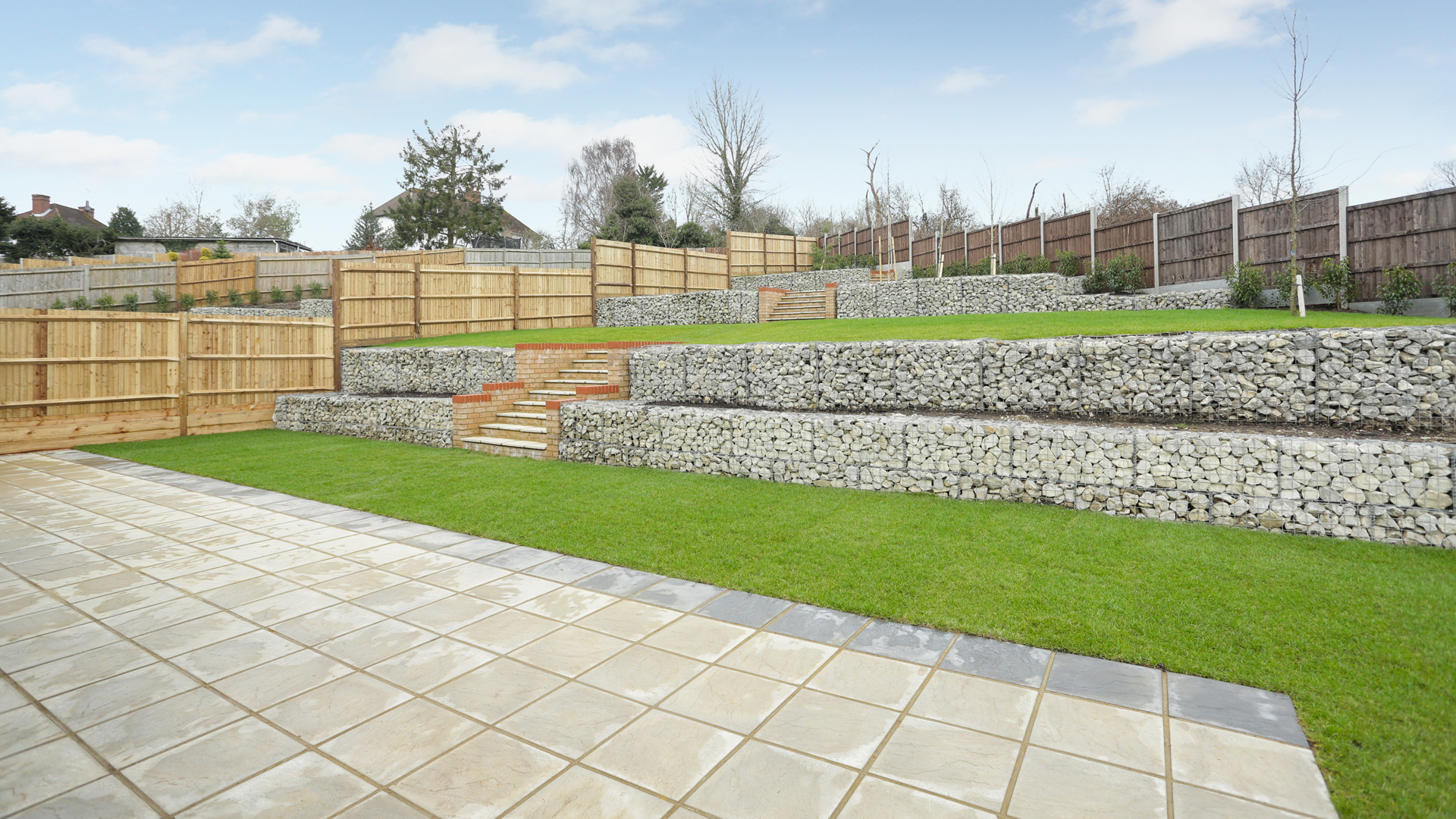 Landscaped Garden at Woodside Court with tiling and grass