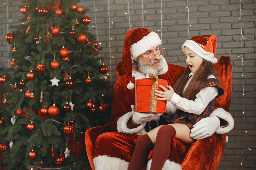 Santa at Christmas giving a child a present