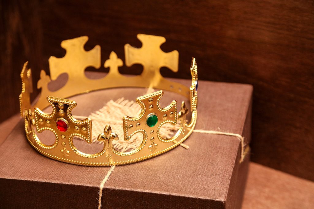 A gold crown on top of a brown parcel