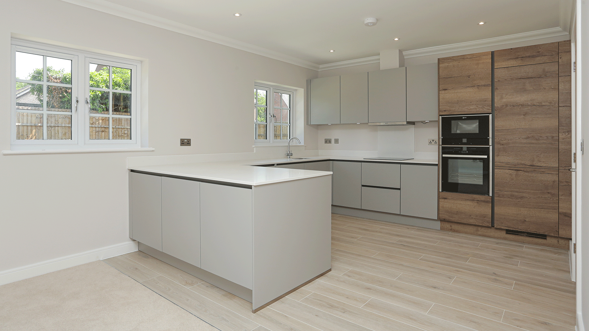 New build bungalow handleless designer kitchen with integrated NEFF appliances at Miller's Meadow plot 9