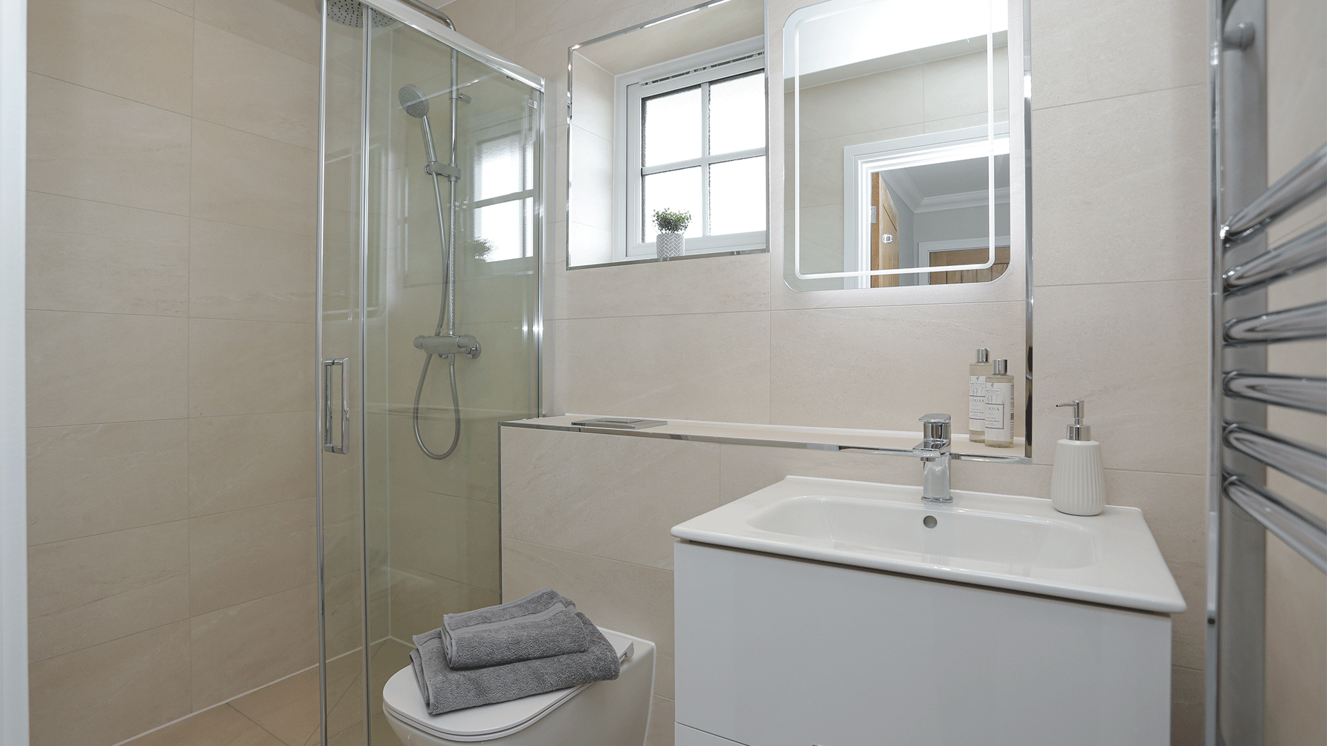 Miller's Meadow Plot 15 ensuite with toilet, sink basin, mirror and wall hung shower