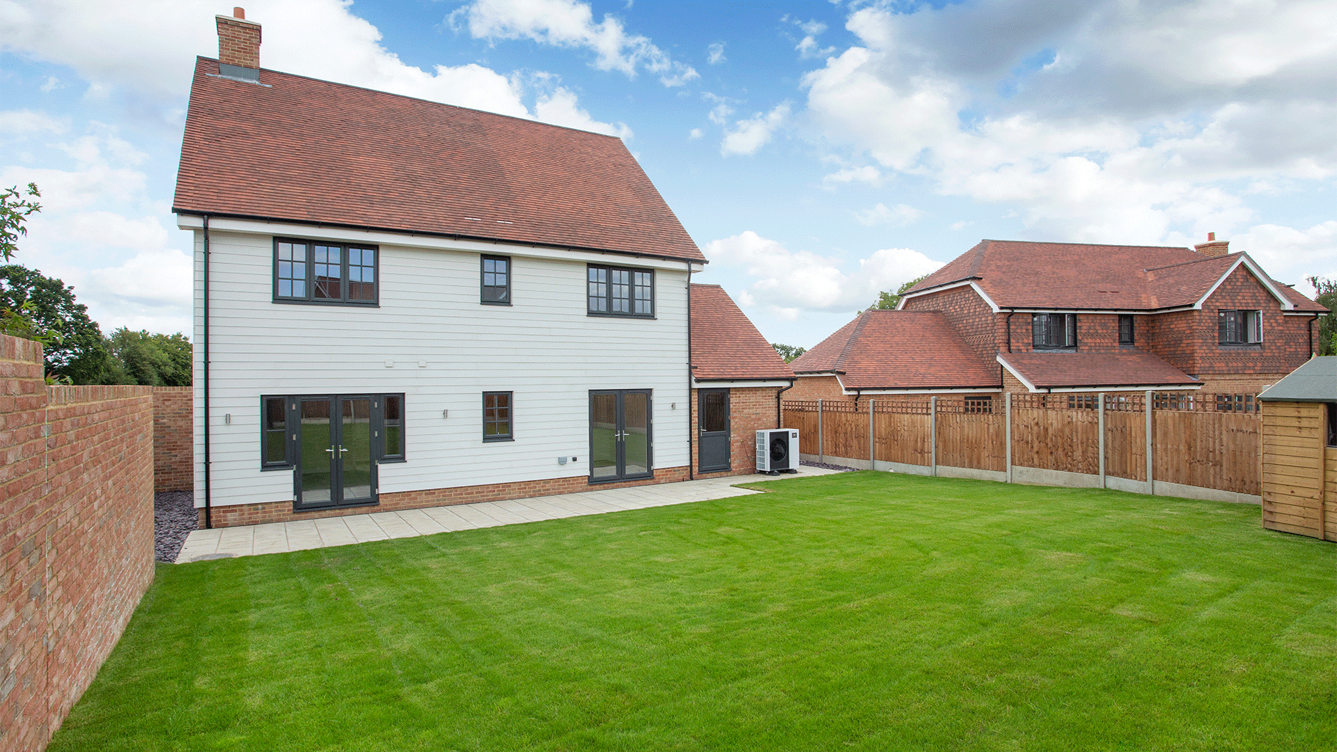 3 bedroom detached house rear view at Miller's Meadow with a landscaped garden and air source heat pump