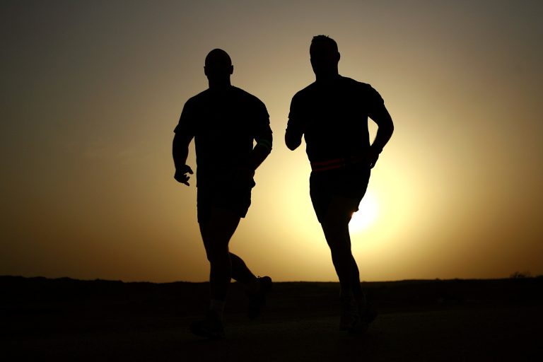 two men running at dusk