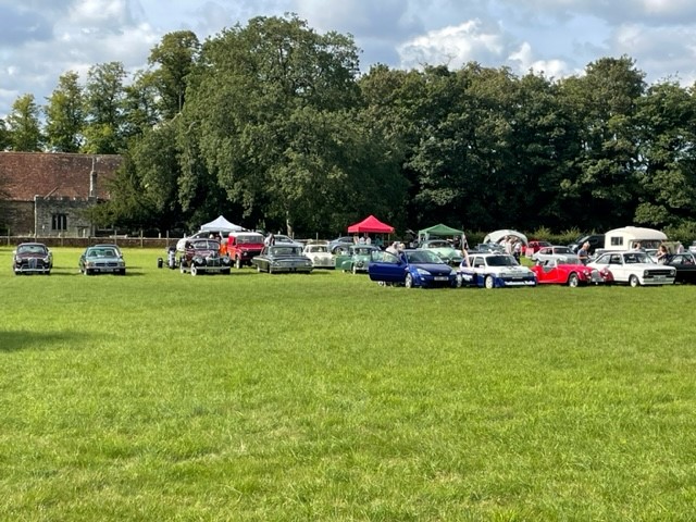 Classic cars on a green field in Thurnham, Kent