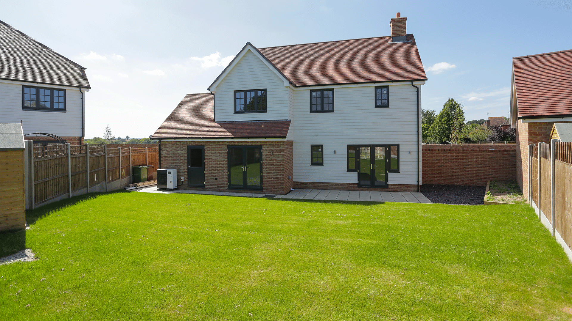 Miller's Meadow - Plot 7 Garden, bright green turf facing the back of a large detached house