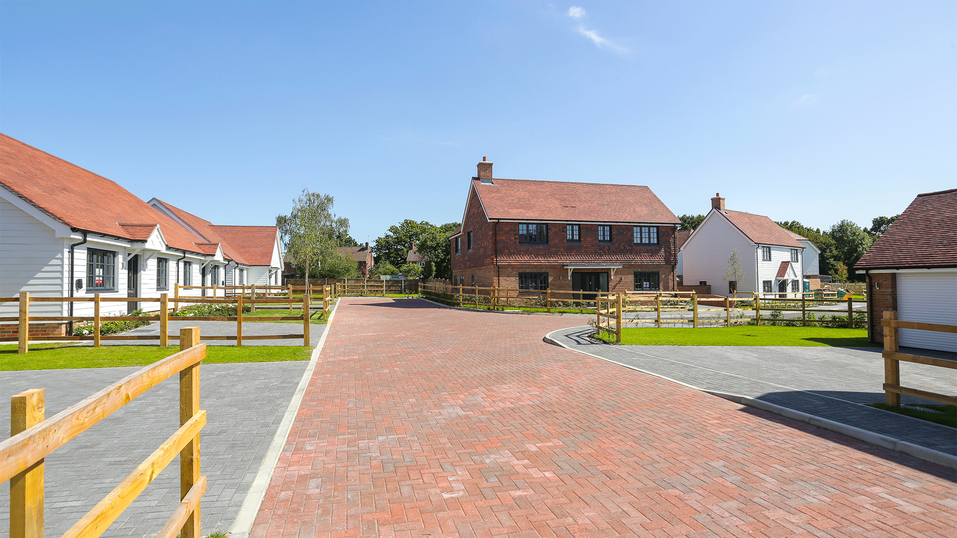 Miller's Meadow Street View close with white bungalows along the left and a large detached house on the right