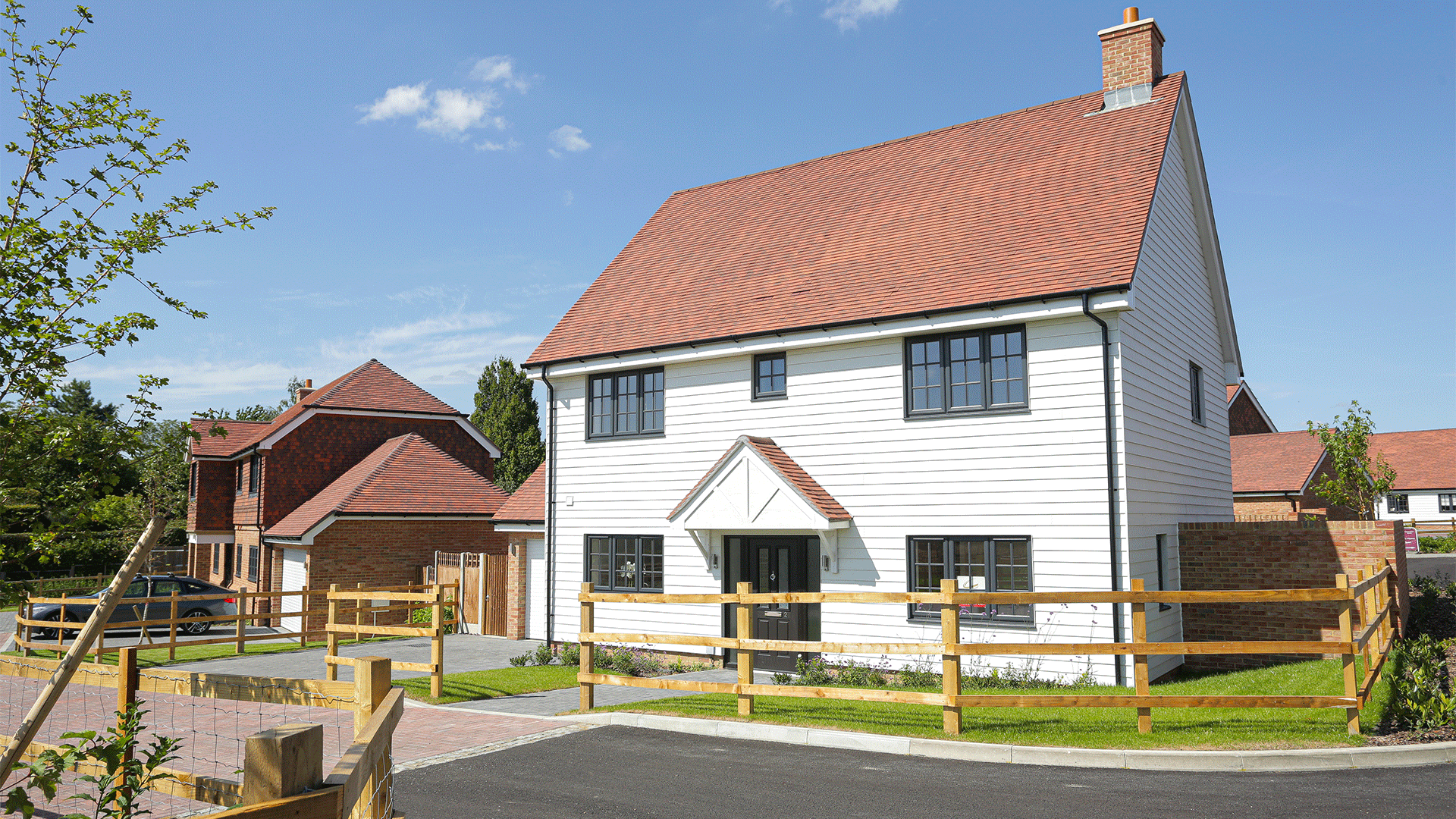 Miller's Meadow Street View featured a large white detached house on a sunny road