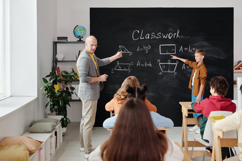 Teacher in front of blackboard