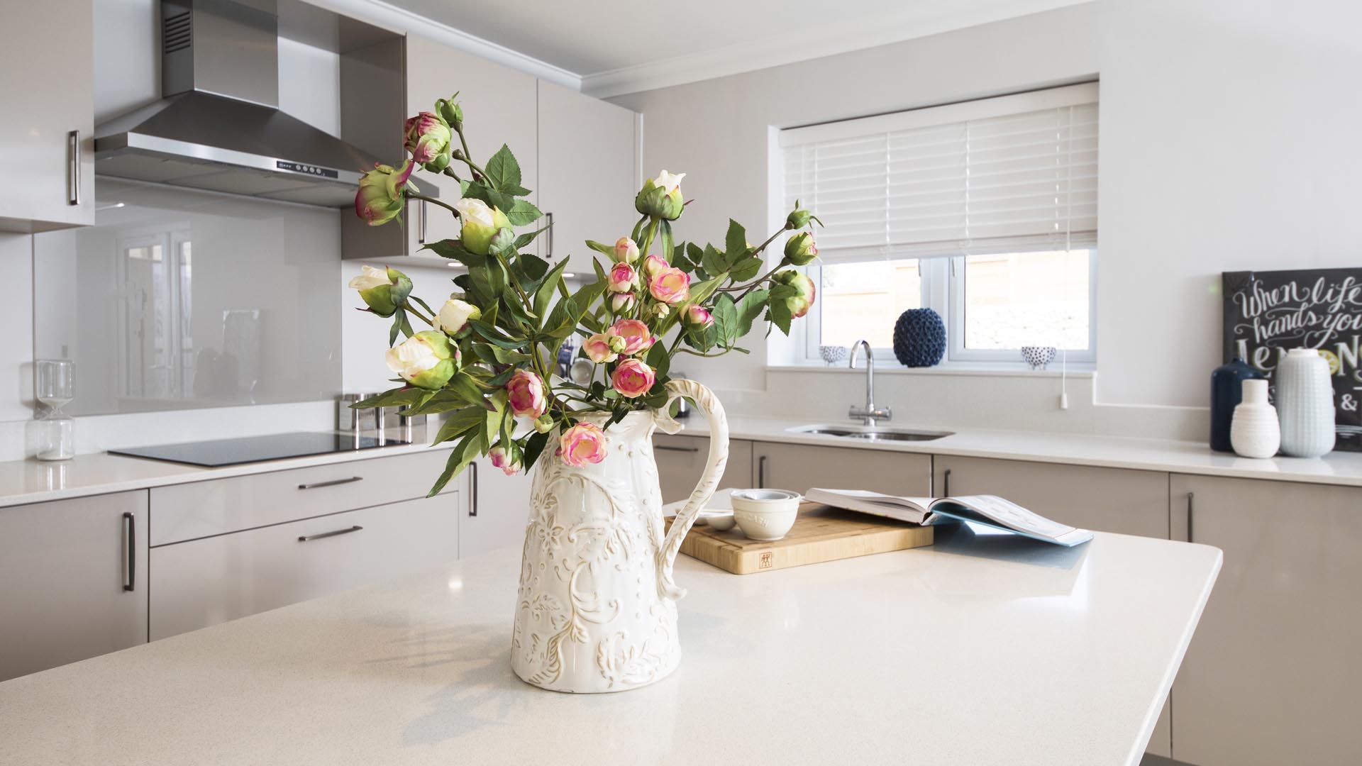 Breakfast bar with vase of roses at Castor park.