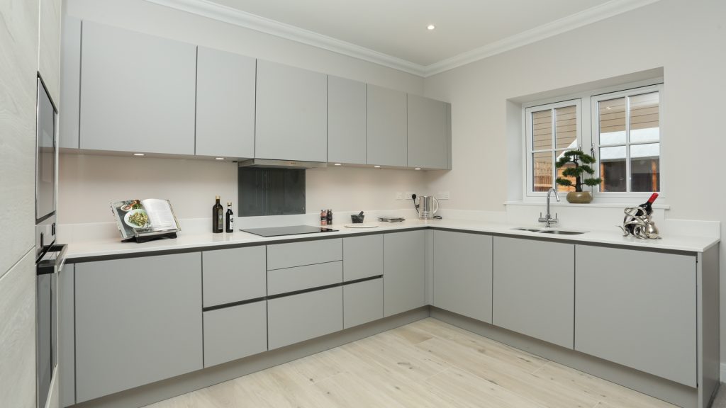 Cobnut Park plot 6 kitchen with grey cupboards and a hardwood floor.