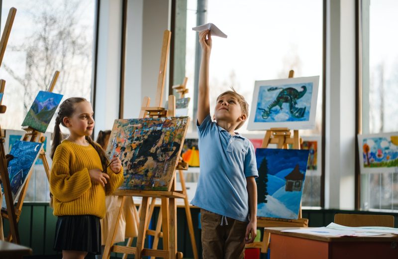 Two school children with drawings