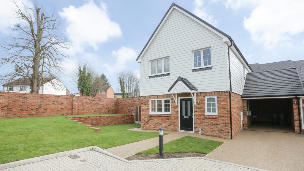 House with landscaped lawn and garage at Ivy Court