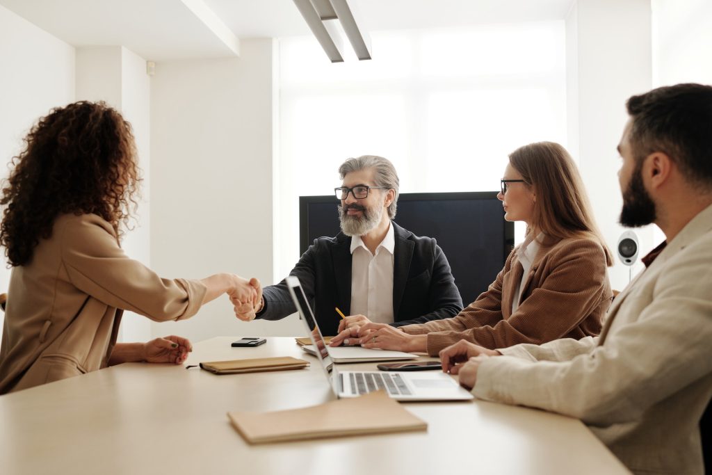 Two people shaking hands in a business meeting