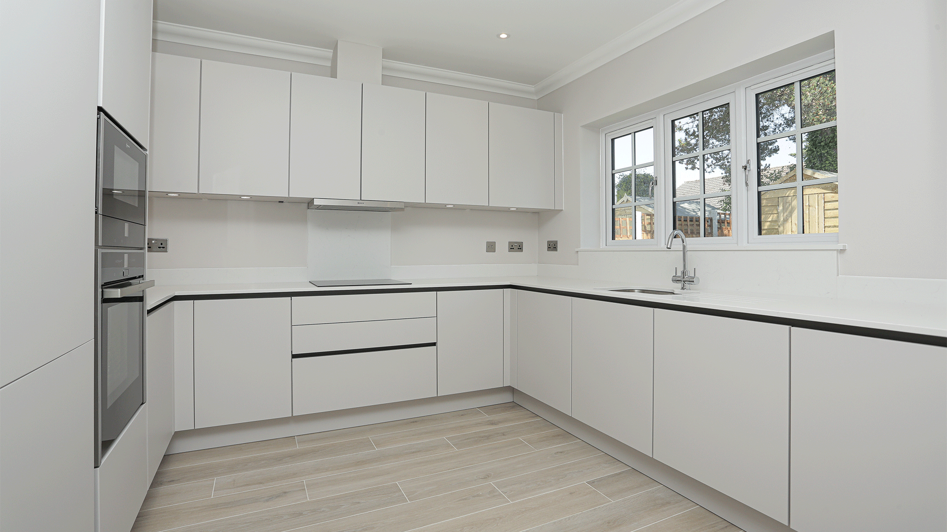 New build bungalow handleless designer kitchen with integrated appliances at Miller's Meadow plot 11