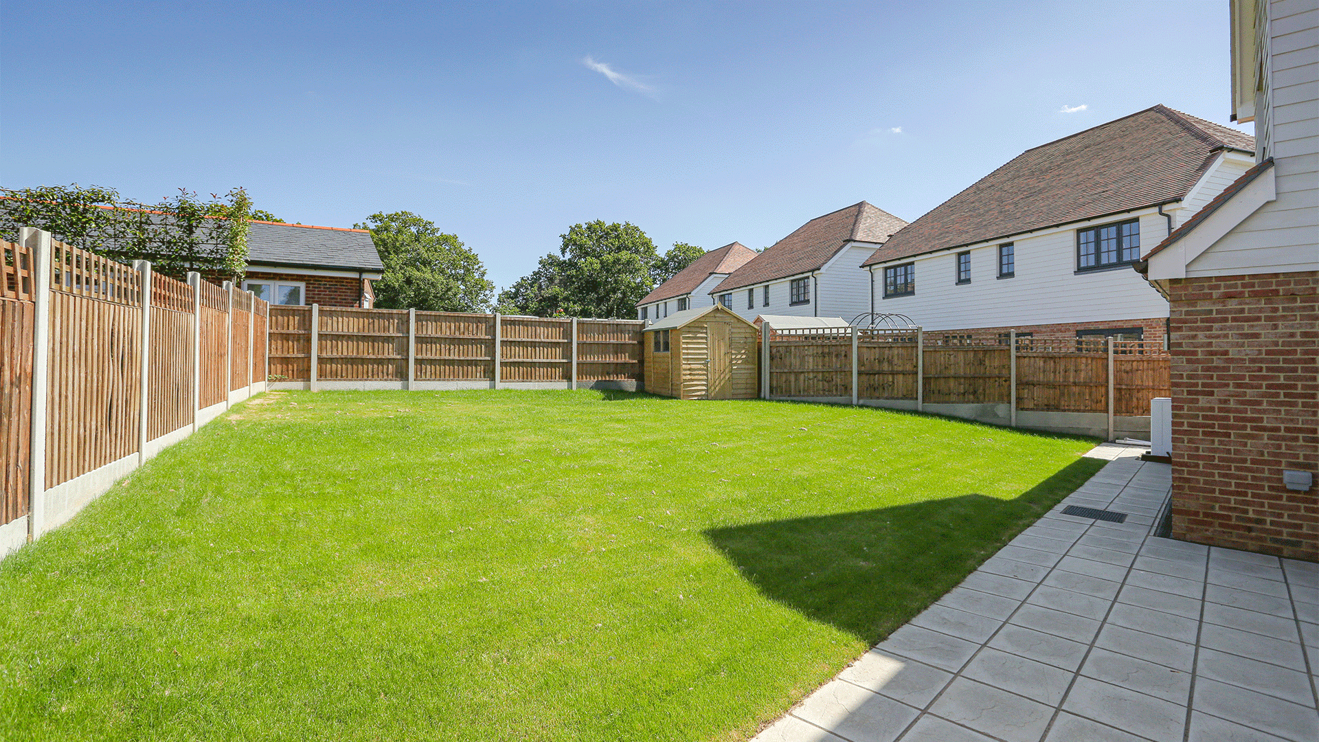 Miller's Meadow - Plot 7 Garden, a bright green turf with a pathway and garden shed on the right