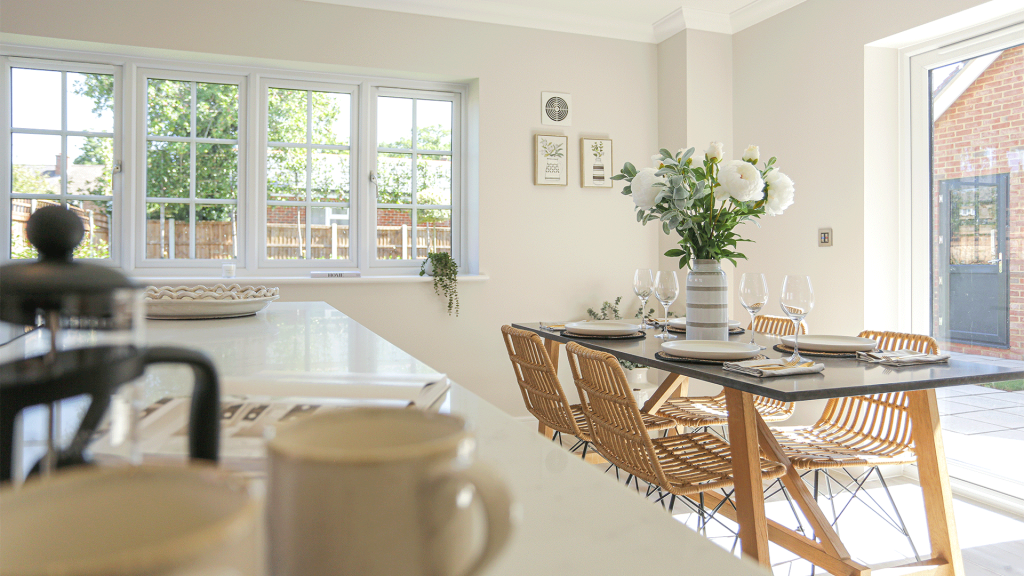 Miller's Meadow - Plot 8 Kitchen with white walls and a wooden dining room table