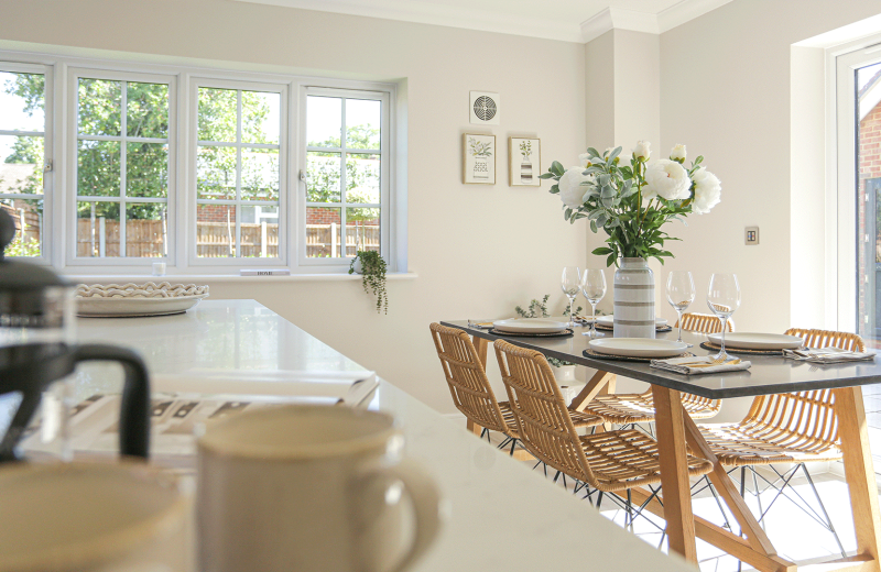 Miller's Meadow - Plot 8 Kitchen with white walls and a wooden dining room table