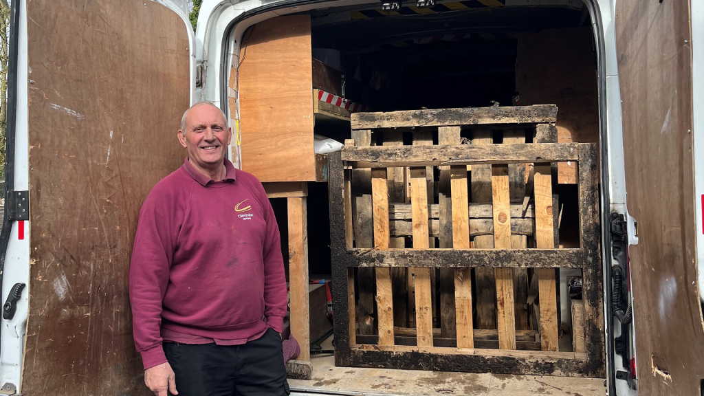 Ian, our driver, standing at the back of his van as its loaded with Pallets