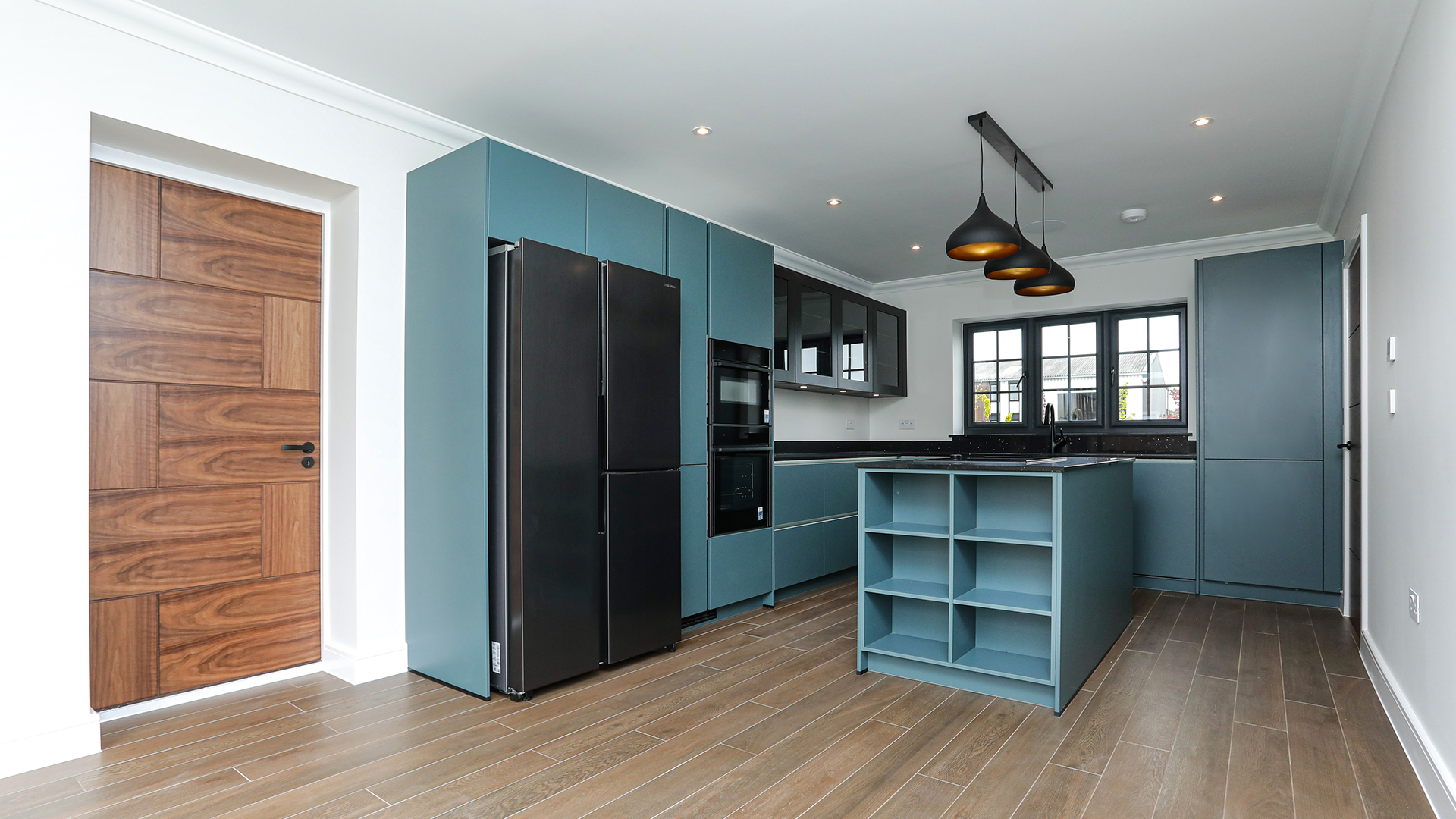 Deep blue kitchen with black worktop