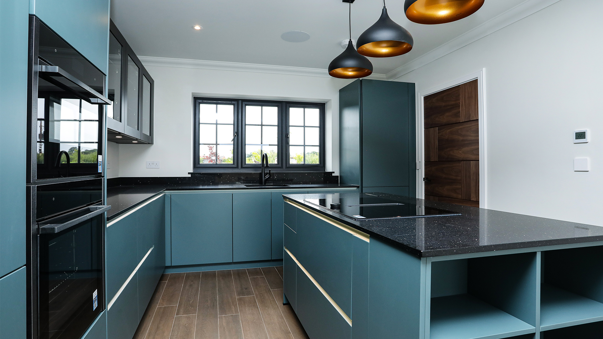 Deep blue kitchen with black worktop