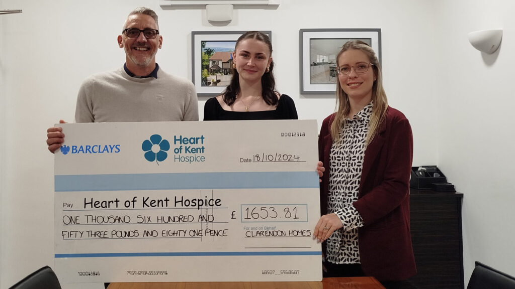 one man and two women holding a cheque donating money to the heart of kent hospice