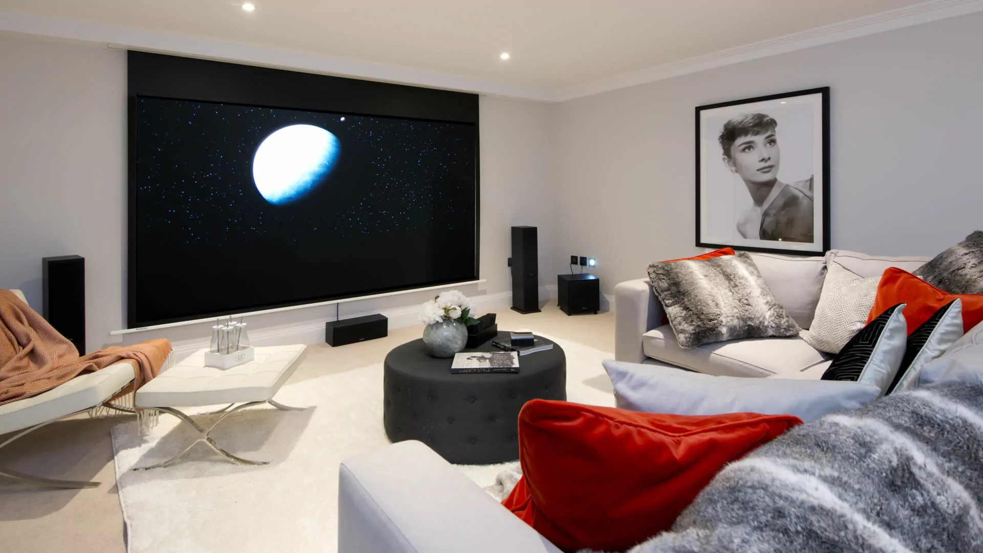 Gables Park plot 1 cinema room, with a large sofa and projector screen.
