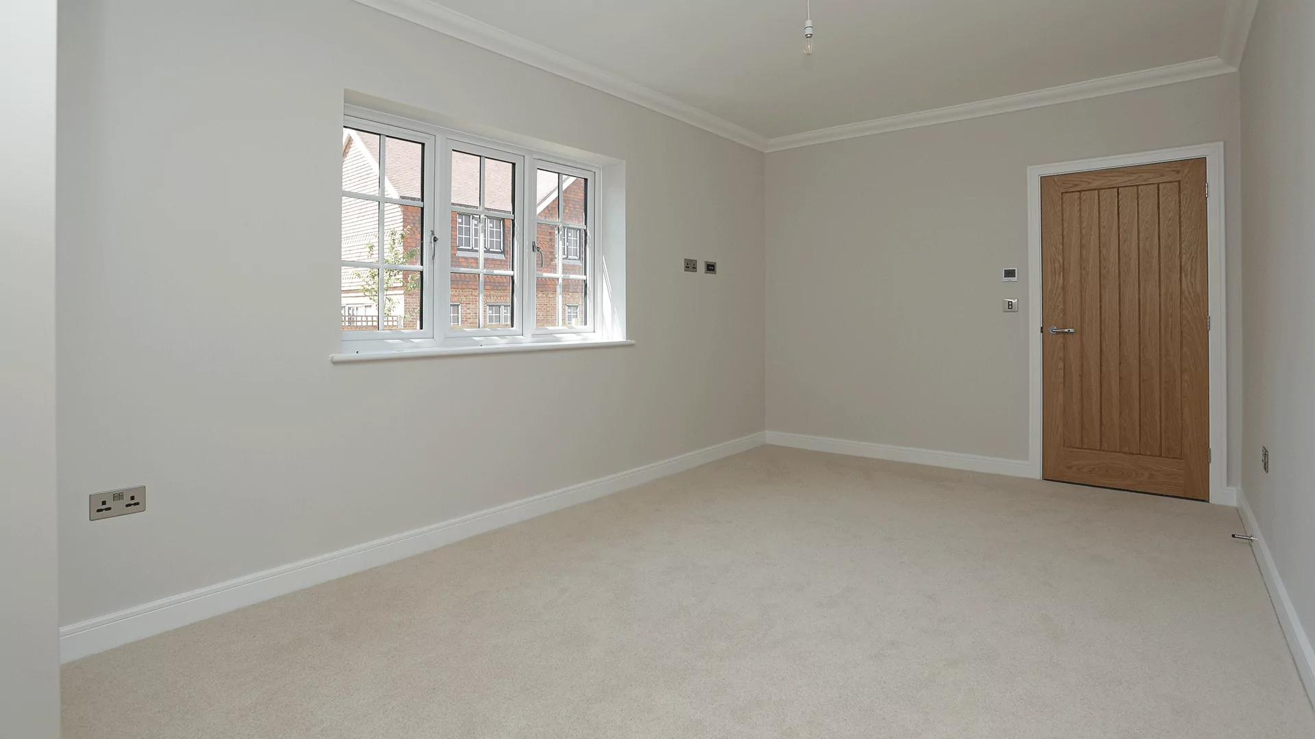 Bedroom with beige carpet and triple windows at Miller's Meadow