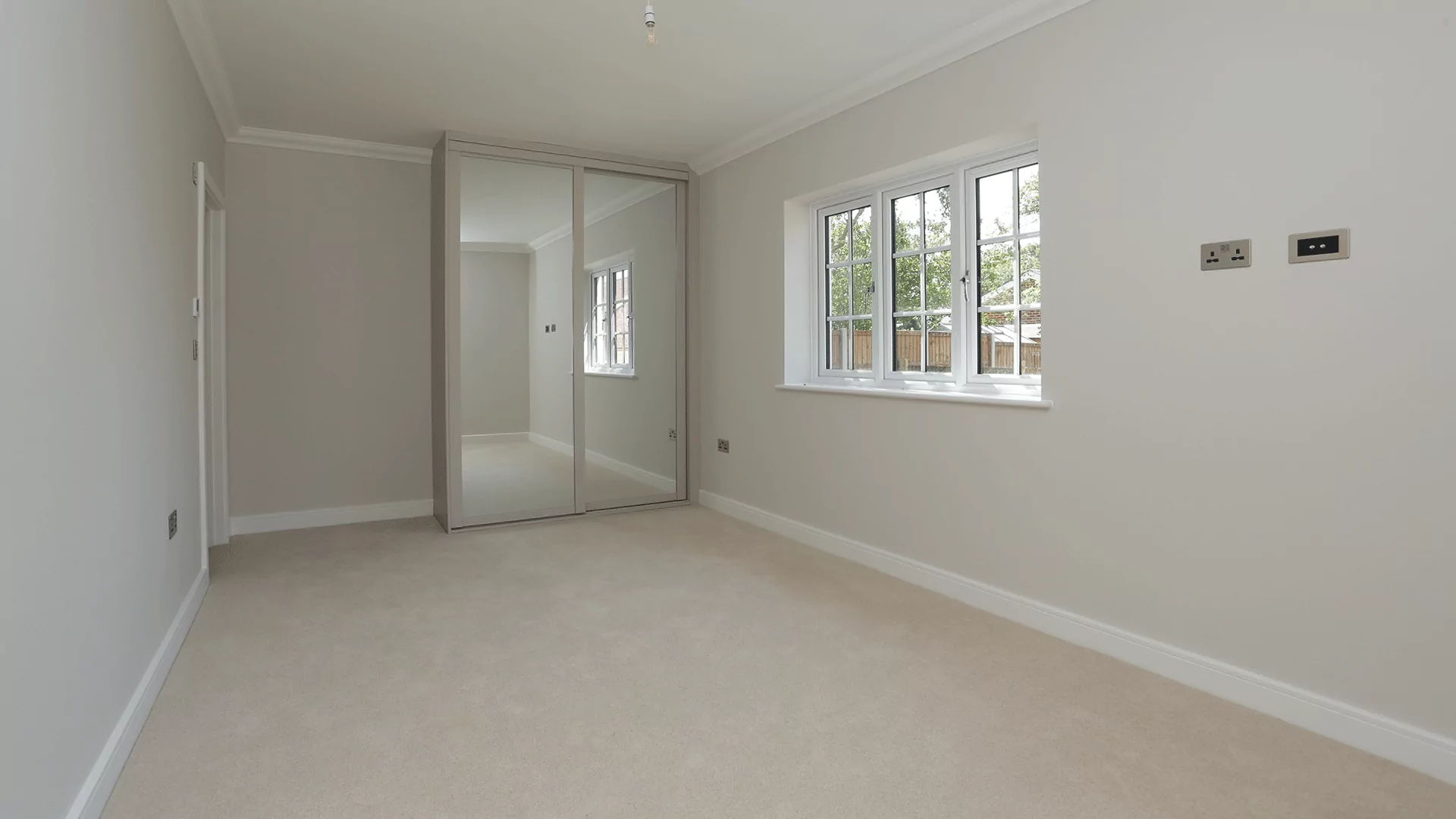 Bedroom with beige carpet and fitted wardrobe at Miller's Meadow