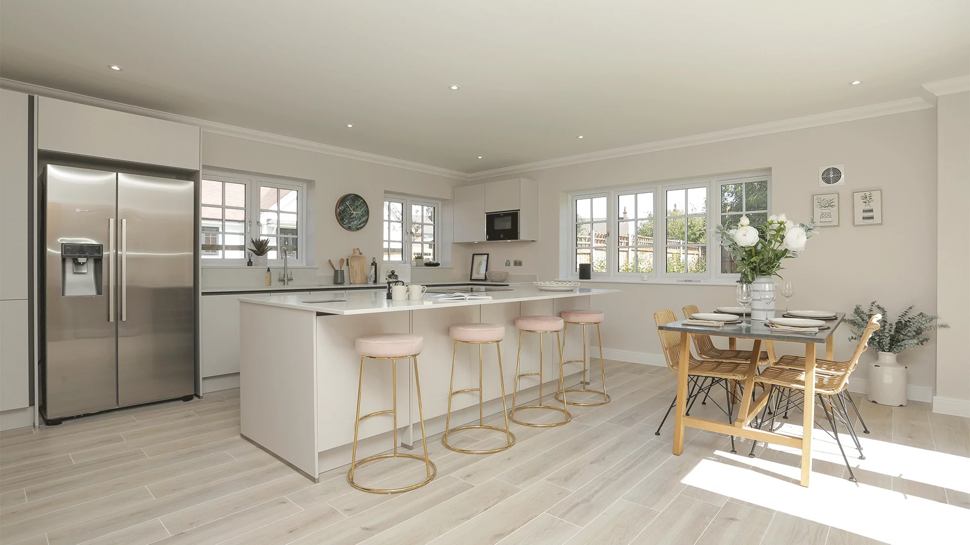 Miller's Meadow Plot 8 wide angle of the open plan kitchen diner with a double fridge and breakfast bar