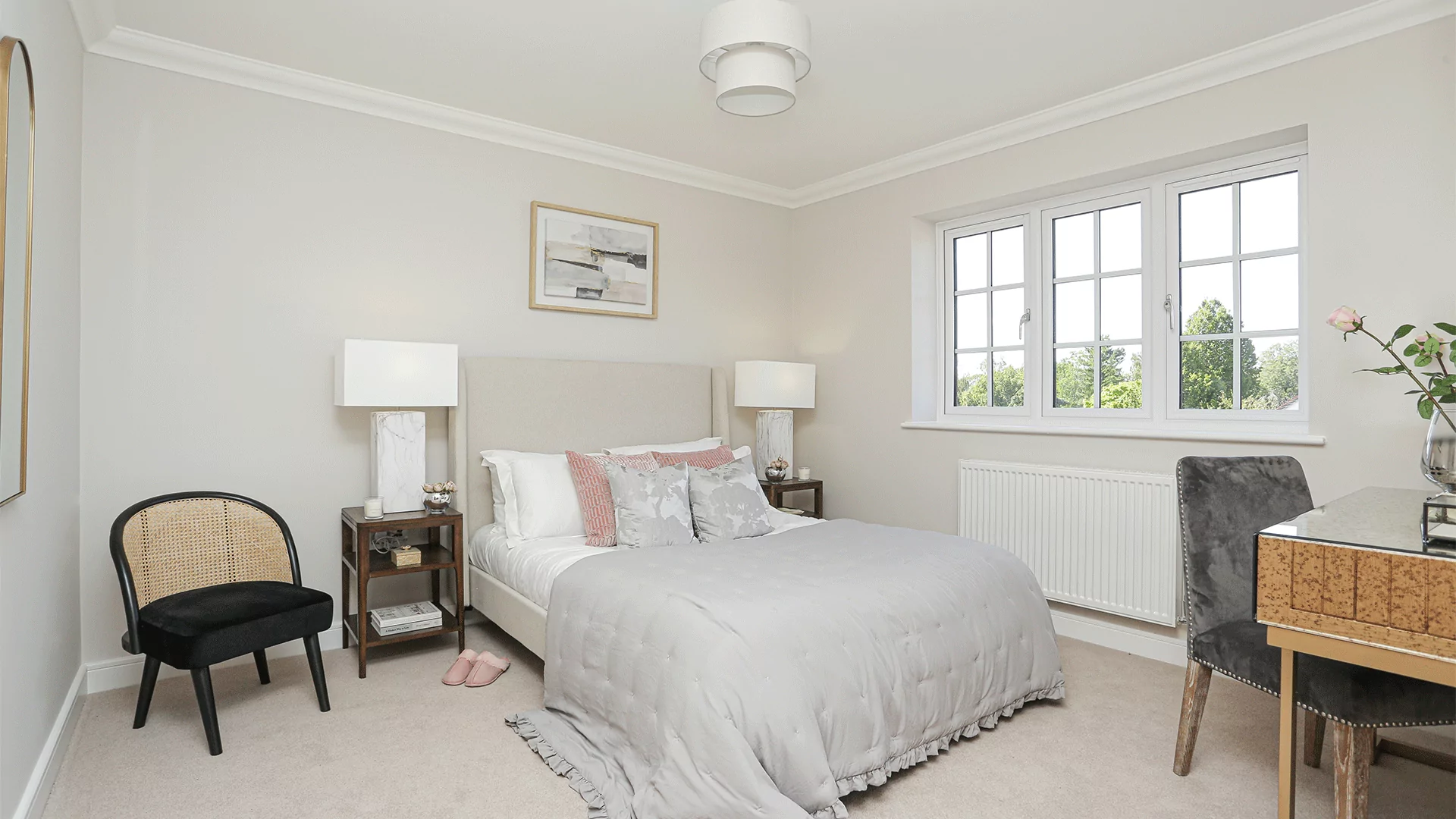 Master bedroom at Millers Meadow plot 8, wide angle including bed, windows, beside tables, chair and lamps